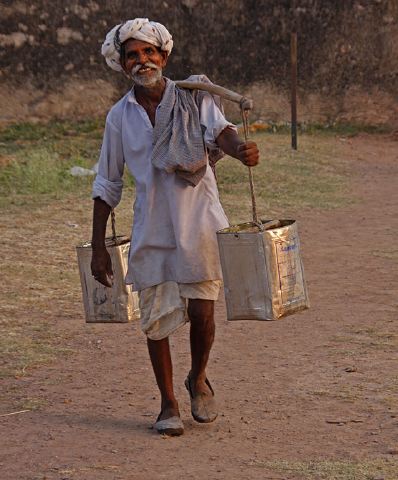 man_carrying_water_buckets.jpg